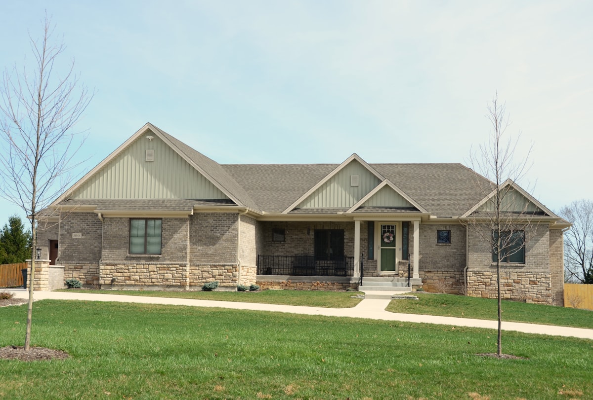 A single-family rental home with a brick exterior and green lawn